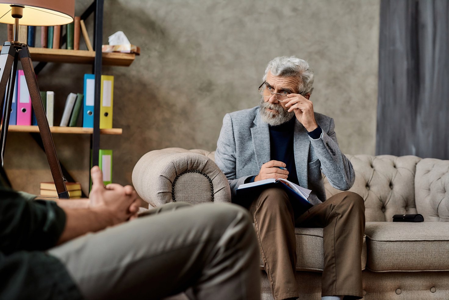 Professional psychotherapist taking notes in office